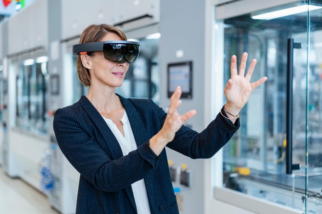 Businesswoman wearing AR glasses in a modern factory
